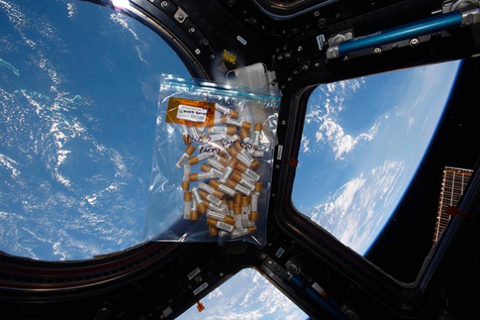 A bag with sampling equipment at the space station, land in the background